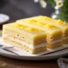 Sliced lemon éclair cake with creamy layers and lemon garnish