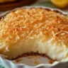 Delicious Crustless Coconut Pie topped with coconut flakes on a plate