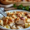 Dolly’s Chicken and Stuffing Casserole served in a baking dish with herbs