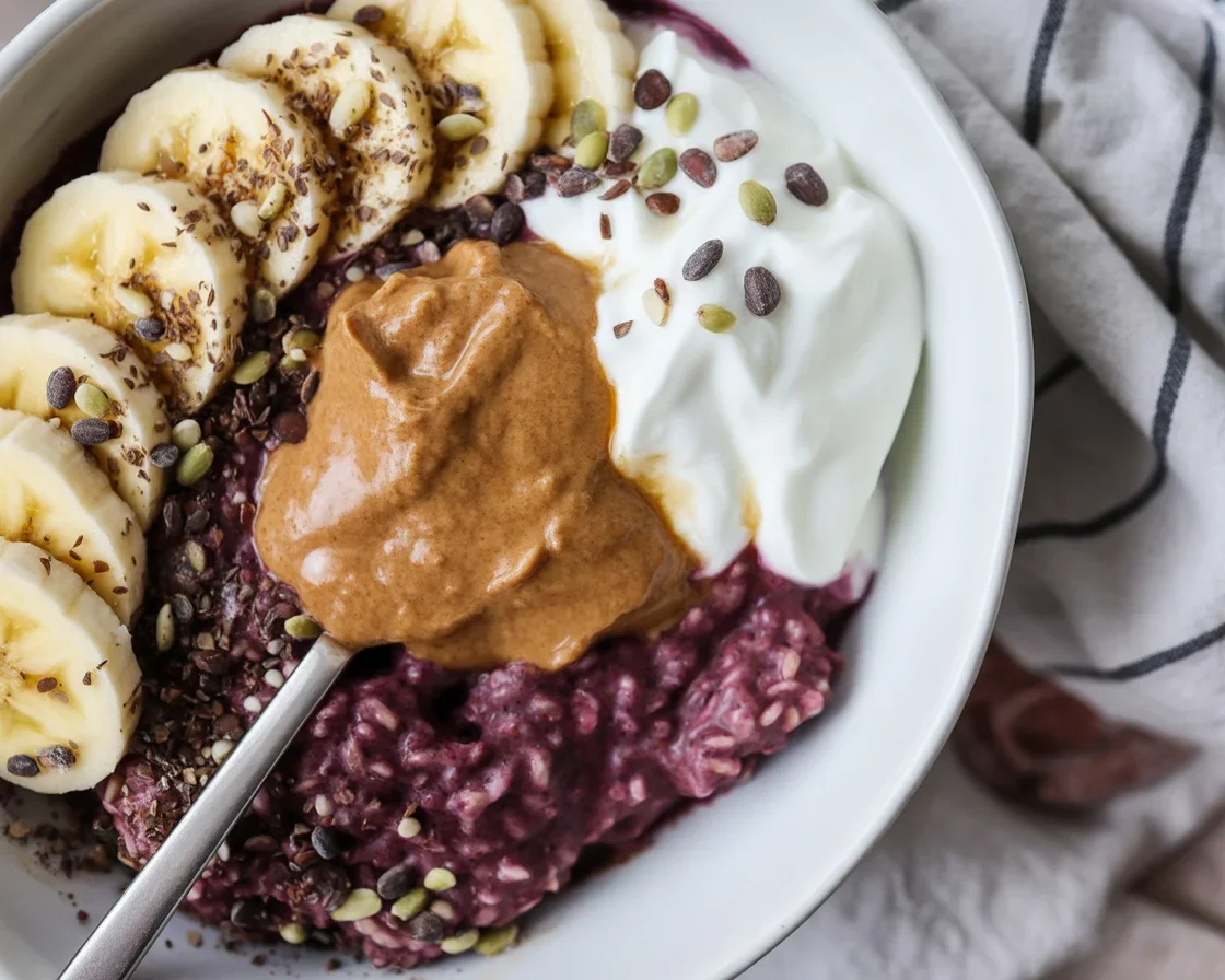 Bowl of steel cut oatmeal topped with fresh blueberries and a sprinkle of cinnamon.