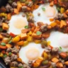 Paleo sweet potato hash with sausage and perfectly cooked eggs for breakfast