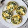 Savory spinach feta breakfast muffins packed with eggs and fresh spinach.
