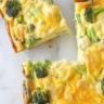 Cheddar and broccoli egg bake in a casserole dish, ready to serve for brunch.