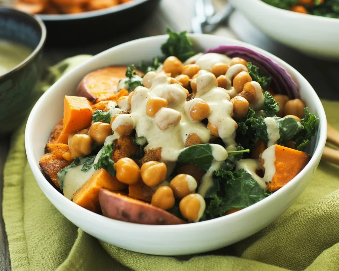 Chickpea Sweet Potato Grain Bowl topped with greens and grains, perfect for a healthy meal.