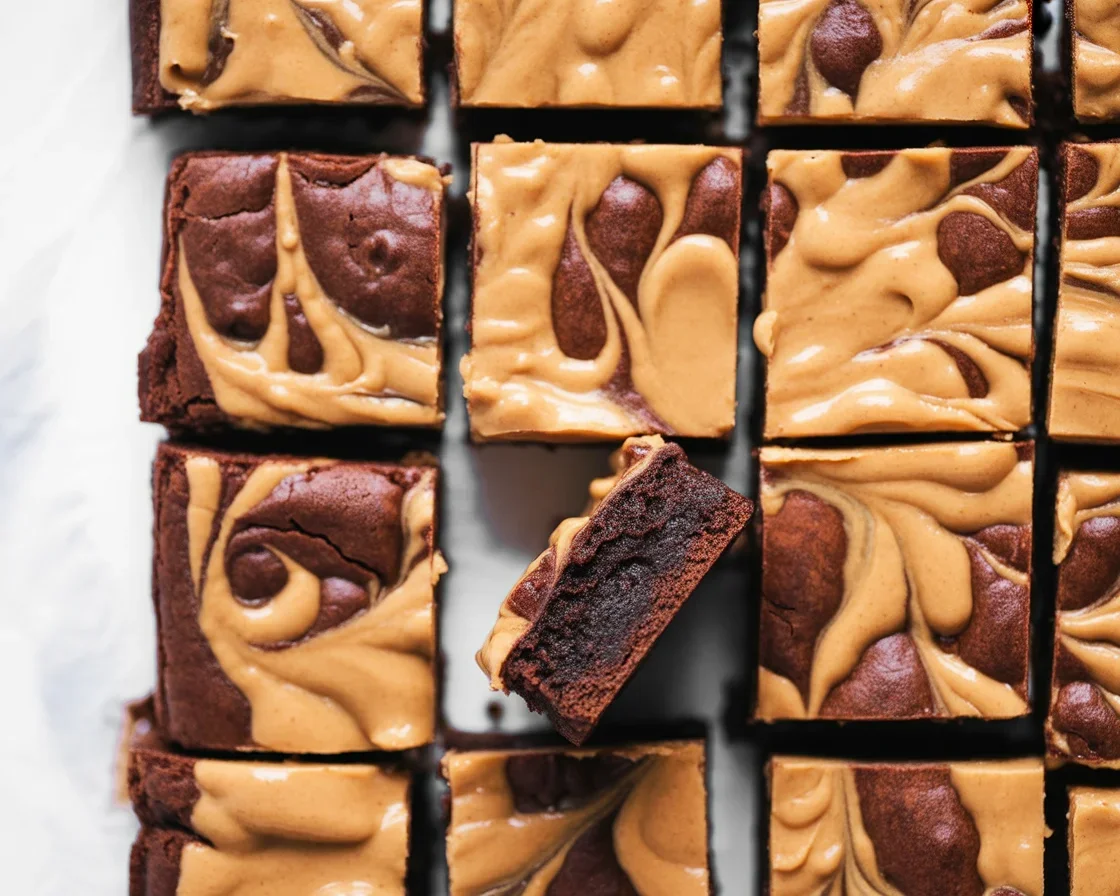 Delicious homemade brownies with a creamy peanut butter swirl, ready to enjoy.