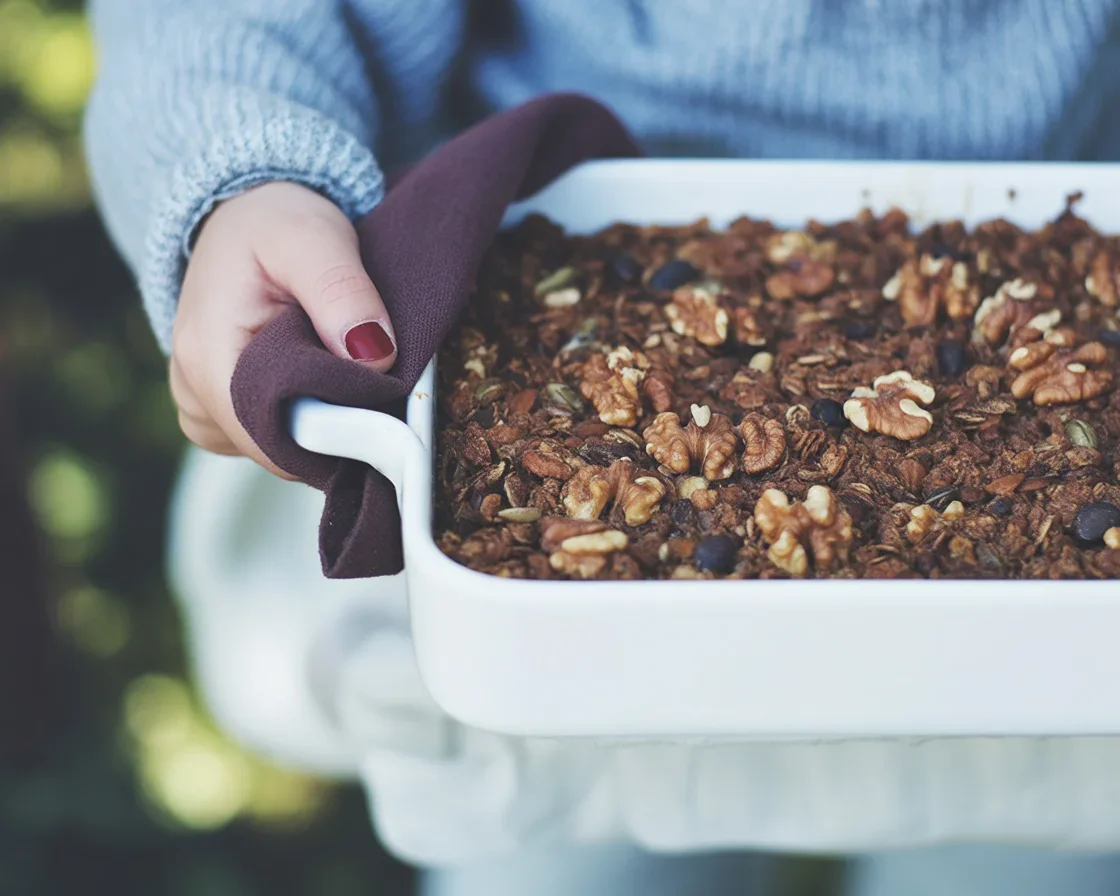 Baked carrot cake oatmeal with walnuts and grated carrots on top.