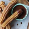 Delicious churros served with rich chocolate dipping sauce for dessert.