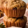 Freshly baked low-sugar bran muffins with raisins on a cooling rack.