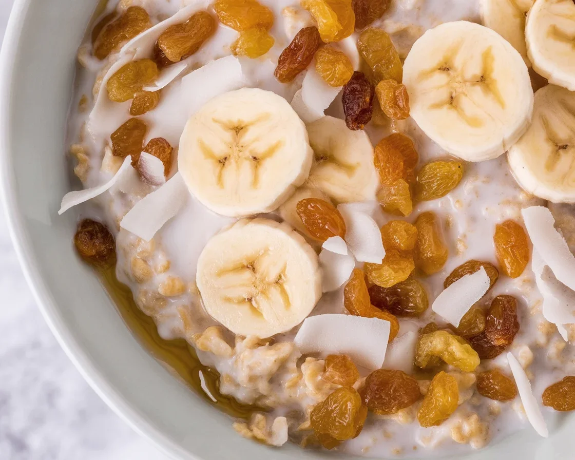 A bowl of multigrain porridge topped with dried fruits and seasonal toppings.