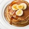 Fluffy banana oat pancakes made without flour, gluten-free breakfast option.