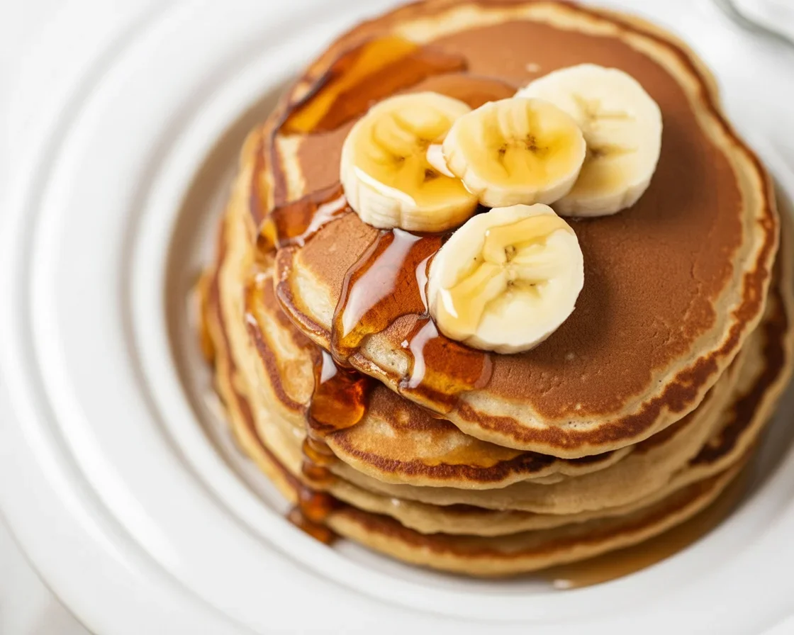 Fluffy banana oat pancakes made without flour, gluten-free breakfast option.
