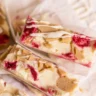 Delicious raspberry white chocolate blondies on a cooling rack.