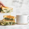 Delicious spinach artichoke grilled cheese sandwich with creamy filling.