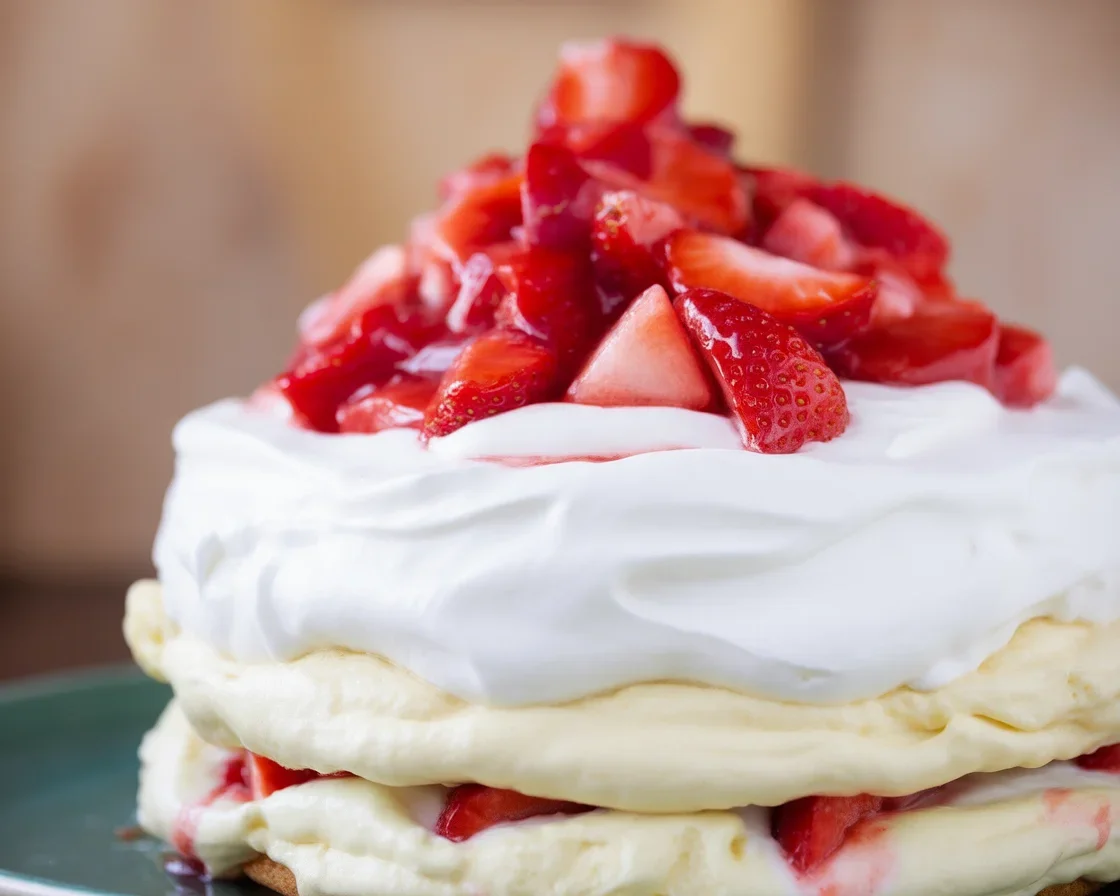 Delicious strawberry shortcake with whipped cream served on a plate.