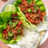 Thai basil beef lettuce wraps served with fresh herbs and vibrant vegetables.