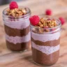 Delicious chocolate chia seed pudding parfait layered with yogurt and fresh berries.
