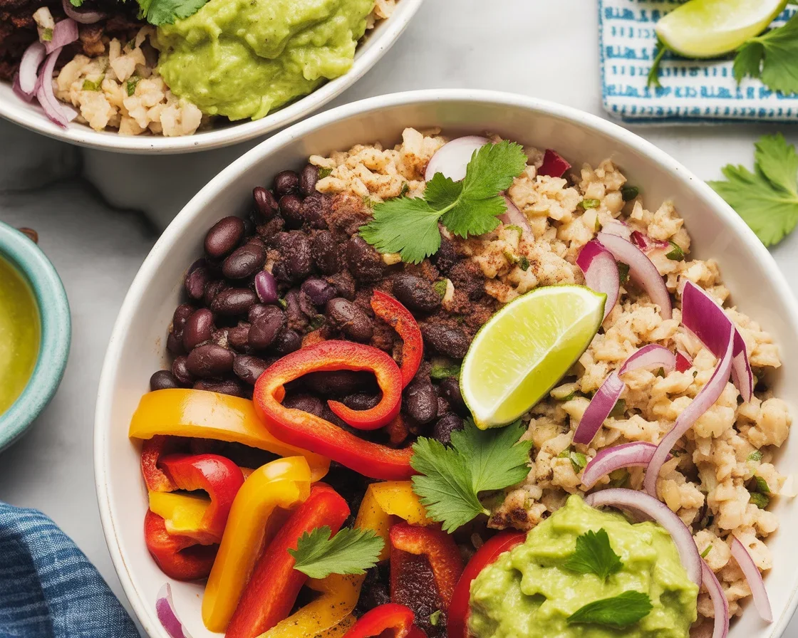 Delicious cauliflower rice burrito bowl with black beans, grilled peppers, and guacamole.