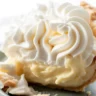 Delicious homemade coconut cream pie topped with fresh whipped cream and toasted coconut.