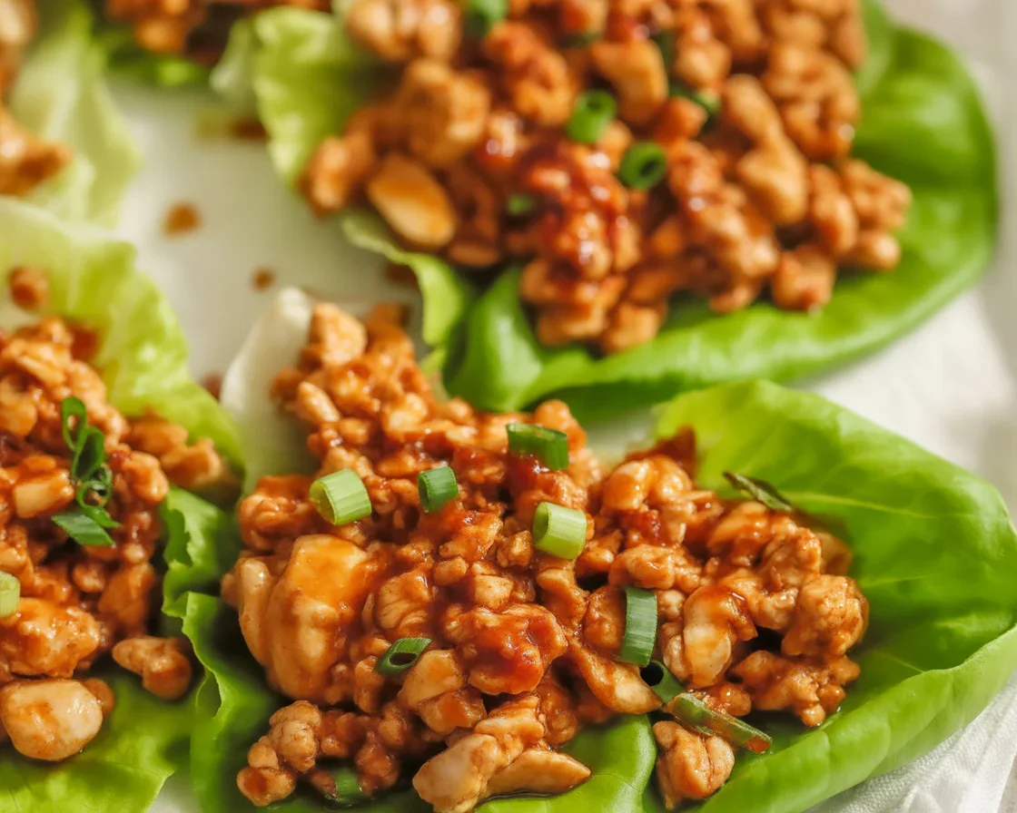 Delicious Asian turkey lettuce wraps served with fresh ingredients and sauce.