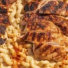 Delicious blackened Cajun chicken Alfredo topped with creamy sauce and herbs.