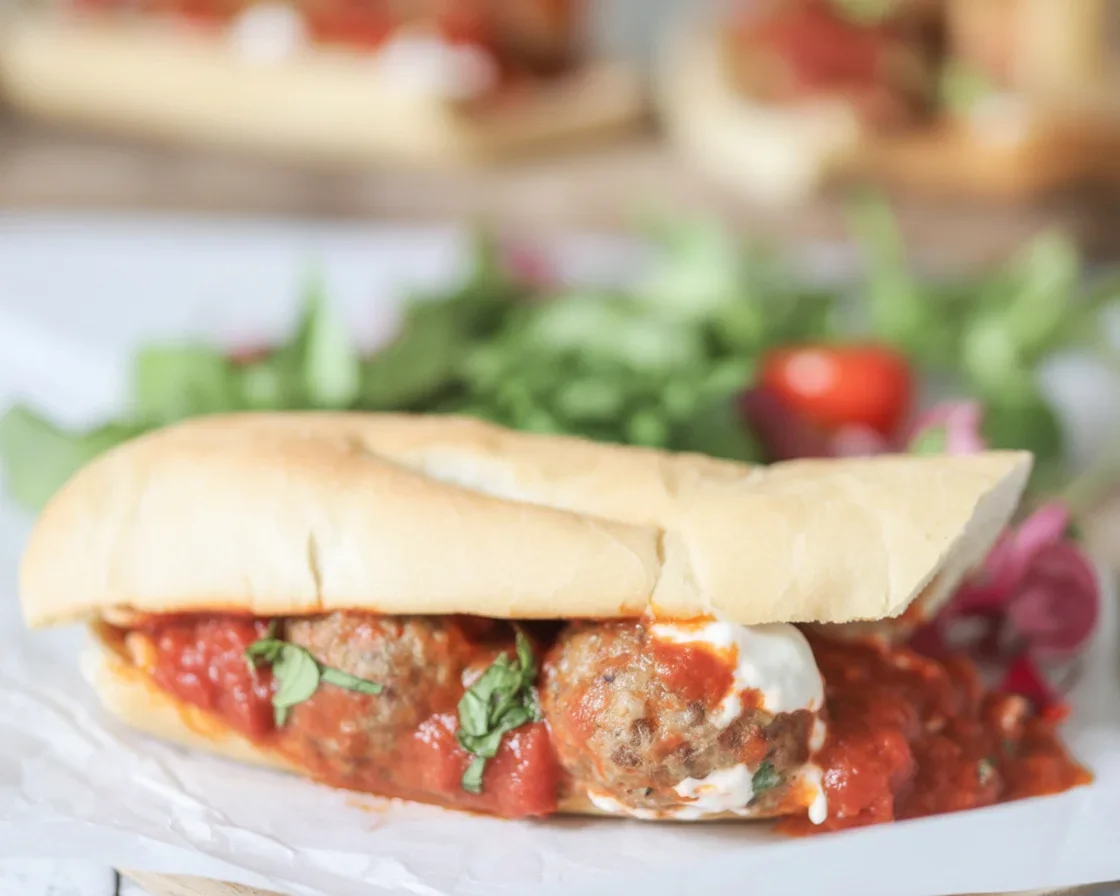 Zucchini turkey meatball sub sandwich with melted cheese and marinara sauce