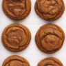 Delicious homemade ginger spice molasses cookies on a baking sheet.