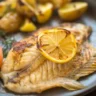 Lemon Garlic Tilapia Foil Packets with herbs and vegetables ready for baking.